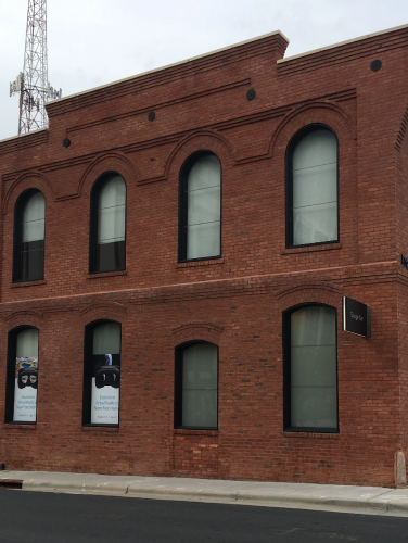 A century-old Victorian Romanesque styled commercial building whose historical offerings have ranged from roofing materials and fertilizer to fiber broadband Internet service.