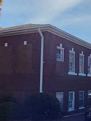 Exterior side view of the two story brick building that served as the Cornelius High School Agriculture Building