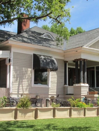 Exterior view of the Mayer House on a sunny day