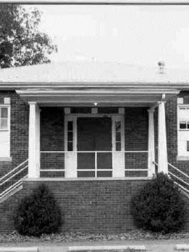 Black and white exterior view of the Huntersville Agricultural Building