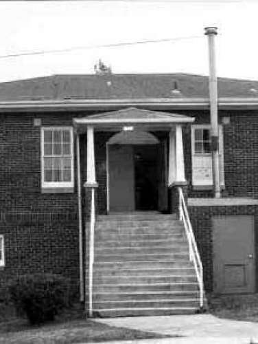 Black and whie exterior view of the Long Creek Agricultural Building