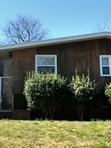 Exterior view of the Tom and Mary Lu Daggy House on a sunny day